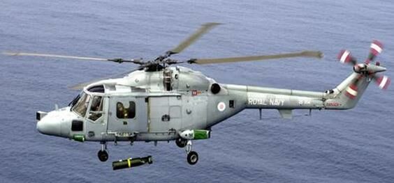 Описание: A Royal Navy Lynx helicopter launches a depth charge during an exercise